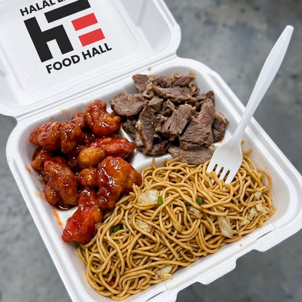 A takeout container with orange chicken, sliced beef, and lo mein noodles, with a white fork.